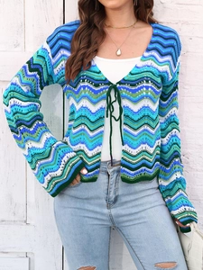 Detail of multi-color striped knit cardigan featuring wave patterns and tie-front closure