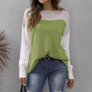 Detail of color-block knit sweater featuring ribbed cuffs and side slit hem design