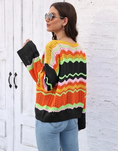 Close-up of rainbow crochet knit texture with colorful wavy stripes on a casual sweater
