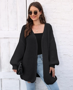 Close-up of black chunky knit cardigan texture and casual long sleeves for women