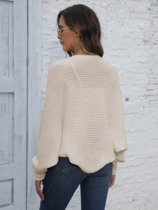 Detail view showing the back of the cream batwing sleeve knit sweater on a model