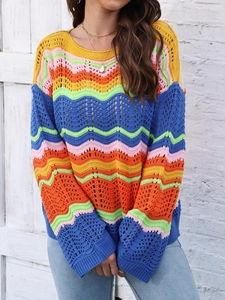 Close-up of bohemian crochet knit sweater with colorful wave patterns and openwork texture