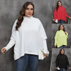 Detail view of oversized knit sweater showing batwing sleeves and ribbed turtle neck textures