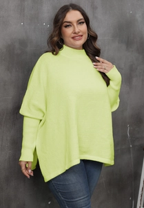 Detail of neon green oversized turtleneck sweater with side slits and ribbed knit textures