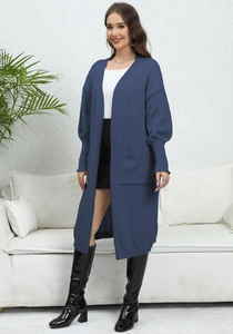 Detailed knit texture of a long grey-blue open cardigan with large front pockets