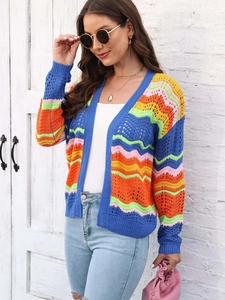 Close-up of rainbow striped knit cardigan featuring wavy crochet patterns and hollow details