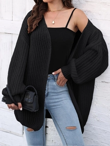 Close-up of black chunky knit cardigan featuring oversized fit and textured knit stitch