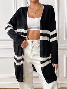 Close-up detail of the knit texture and black and white stripes on long cardigan