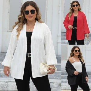 Detail view of long-sleeve pleated cardigan in white, red and black showing texture