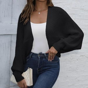 Close-up of black knit cardigan featuring elegant lantern sleeves and fine texture details