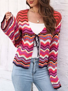 Detail of colorful wavy knit pattern and tie-front closure on a crochet cardigan