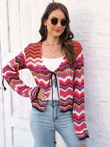 Close-up of rainbow crochet knit cardigan with wave stripes and front tie closure
