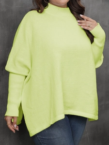 Detail of lime green knit sweater featuring a high neck and ribbed cuff texture