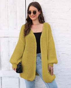 Detail of chunky knit mustard yellow cardigan showing heavy texture and loose weave