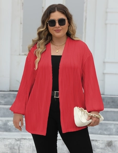 Detail of red pleated mid-length cardigan showing premium vertical texture and loose fit