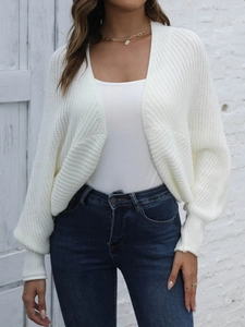 Detail of white knit cardigan showing ribbed texture and stylish lantern sleeve cuffs