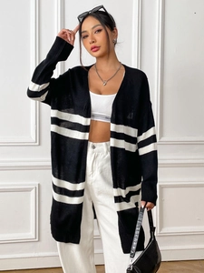 Close-up of black and white striped knit cardigan texture and premium woven fabric