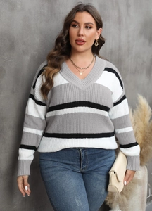Detail of V-neck color-block sweater with gray, white, and black striped knit texture