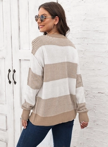 Détail du pull rayé oversize montrant la maille camel et blanche et les poignets côtelés