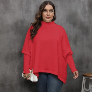 Detail of red oversized turtleneck sweater with batwing sleeves and ribbed knit texture