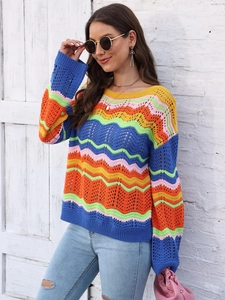 Detail of multi-color wavy crochet knit fabric on women's rainbow striped sweater
