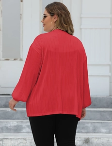 Detailed back view of red oversized cardigan featuring textured vertical pleated wave pattern