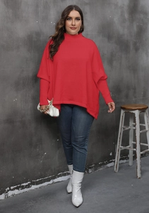Close-up of red oversized mock neck sweater with batwing sleeves on a female model