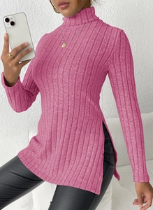 Detail view of rose pink ribbed knit sweater featuring side split hem and slim fit design