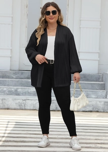 Detailed view of lightweight black pleated cardigan fabric and stylish lantern sleeve