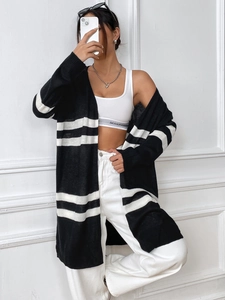Detailed knit texture of a black and white striped long cardigan for casual women's wear
