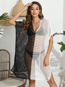 Detailed texture of black and white color-block hollow knit beach cover-up with V-neck