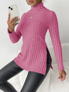 Detail view of rose pink high neck sweater with vertical ribbed texture and side slit