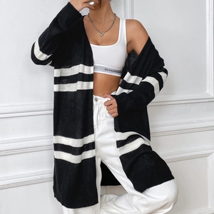 Close-up of black and white striped knit cardigan with loose fit and premium fabric texture