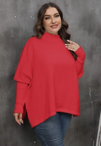 Detail showing side split hem and textured knit of red mock neck batwing sweater