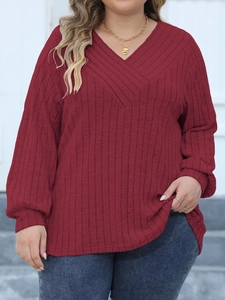 Close-up of ribbed texture and V-neckline on wine red long sleeve casual knit top