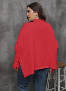 Detail of red oversized knit sweater featuring a high neck and side split hem design