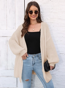 Detail of loose fit cream knit cardigan featuring coarse weave texture and drop shoulder