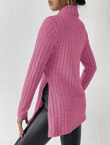 Detail view of pink turtleneck sweater featuring ribbed texture and side slit design