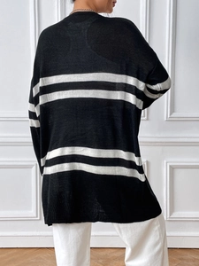 Back view of a loose-fit knit cardigan with black and white horizontal stripes for women