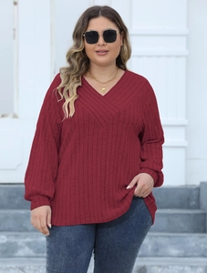 Detailed view of the ribbed texture and cross V-neck design on the burgundy knitted top