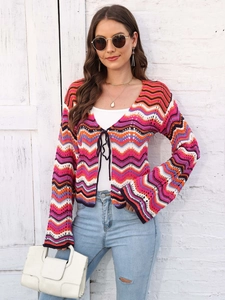Close-up of colorful rainbow wave knit cardigan with tie closure and flared sleeves