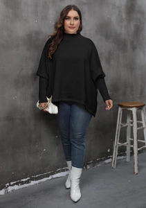 Detail of loose oversized black knit sweater with batwing sleeves and mock neck style