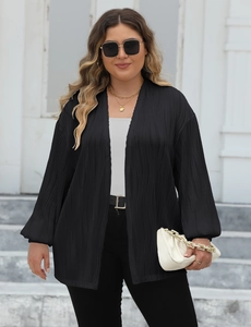 Close-up of the textured vertical pleated fabric on a casual black open front cardigan