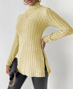 Detail of ribbed turtleneck sweater showing high side slit and soft knitted texture