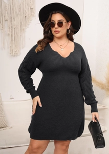 Detail of the deep V-neckline and textured knit sleeves on this black midi dress