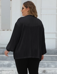 Detailed back view of a black pleated oversized cardigan with long lantern sleeves