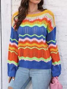Close-up of multicolor rainbow striped hollow out knit sweater with wavy crochet pattern