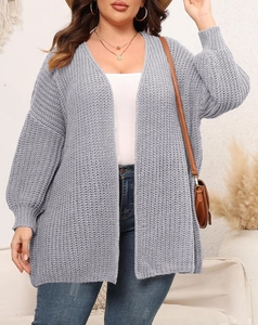 Detail of grey chunky knit cardigan with ribbed cuffs and loose fit casual style