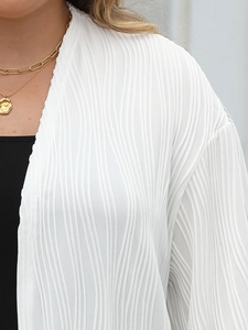 Detailed view of white pleated cardigan fabric texture and flowy long lantern sleeves