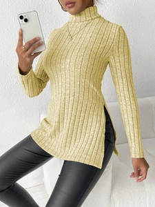 Detail shot of long sleeve ribbed turtleneck sweater with high side slit in ginger yellow